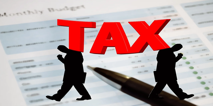 Graphic showing the word TAX weighing down on silhouettes of stressed individuals, symbolizing the financial burden of estate taxes in Canada