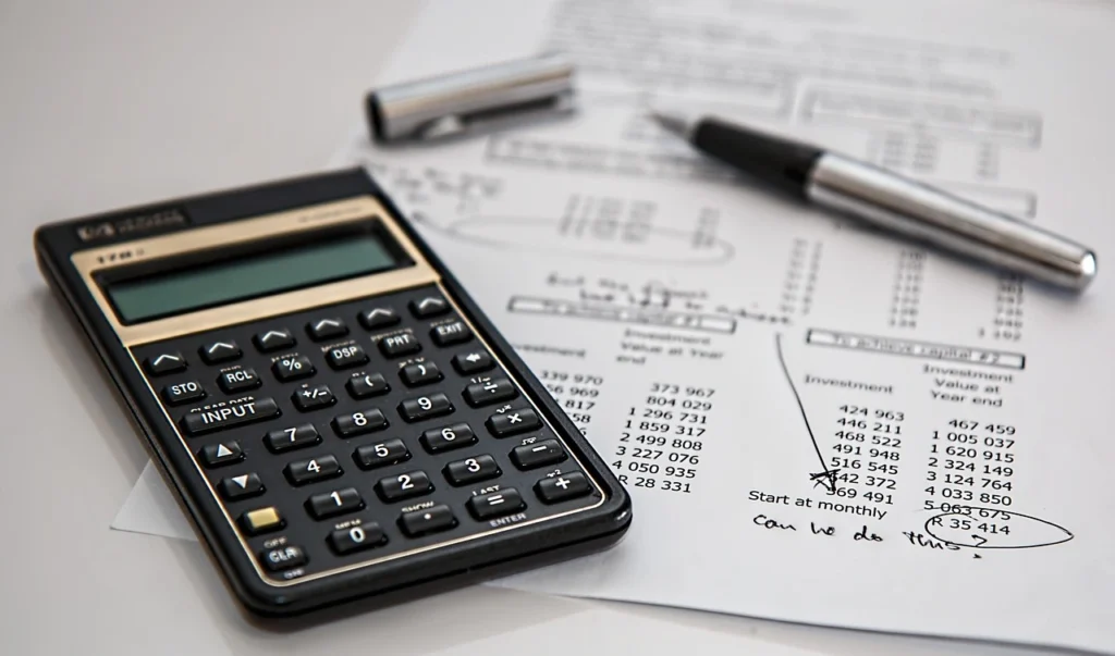 Business professional reviewing financial documents and calculating year-end tax planning figures
