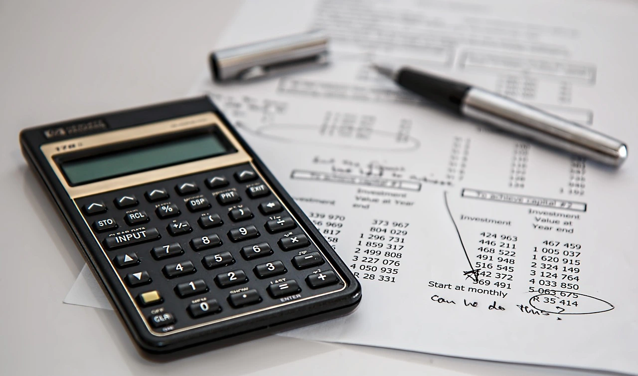 Business professional reviewing financial documents and calculating year-end tax planning figures