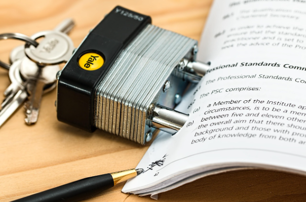 Padlock securing professional standards documents representing audit assurance and compliance requirements